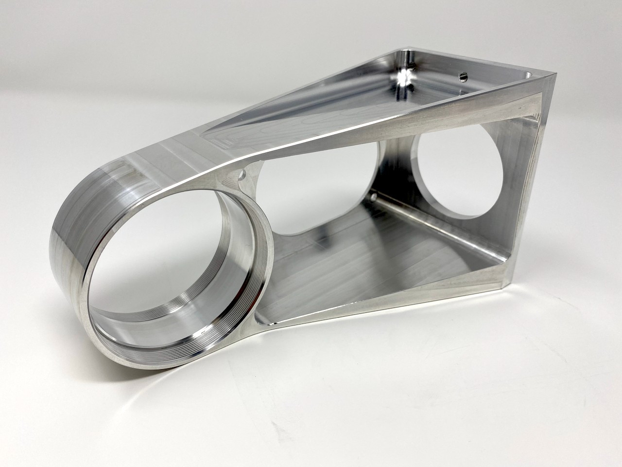 Machined aluminum clevis link arm with two precision bores.